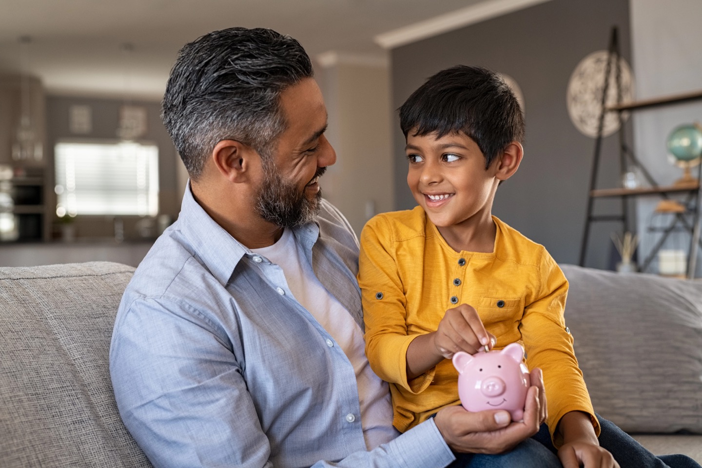 A father and child saving coins together